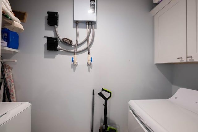 453 Lime Dr, Key Largo, FL 33037 - laundry room featuring separate washer and dryer, cabinet space, and water heater