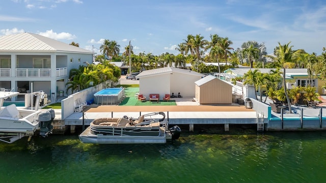 dock area with a water view and fence