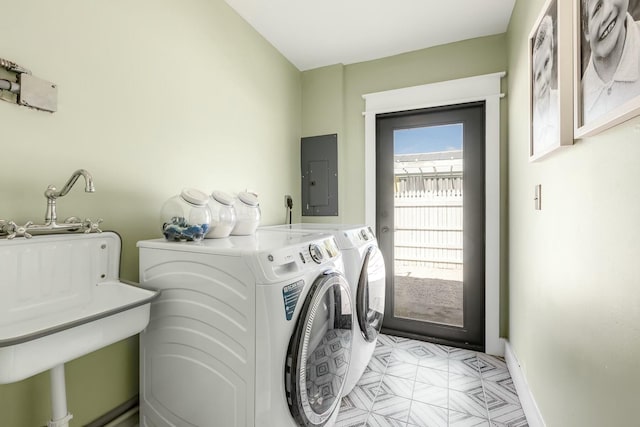 laundry area with light floors, separate washer and dryer, laundry area, electric panel, and baseboards