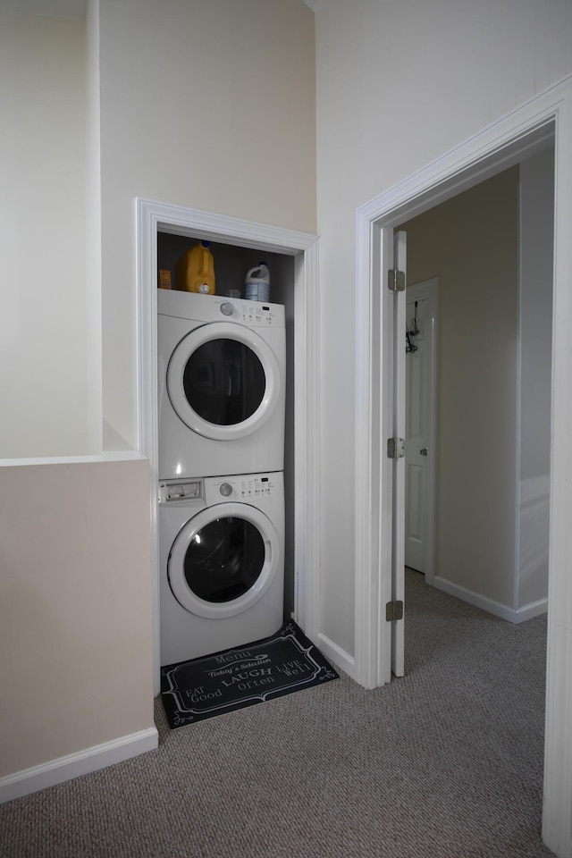 laundry room with stacked washer and dryer and carpet