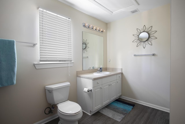 bathroom with vanity, wood-type flooring, and toilet