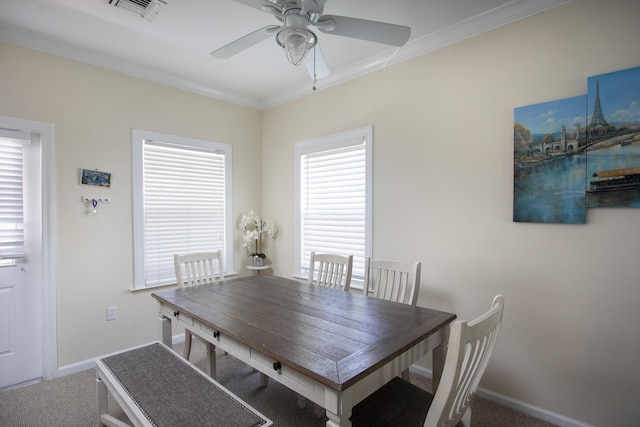 unfurnished dining area featuring crown molding, ceiling fan, and carpet flooring