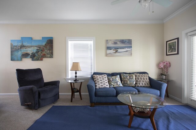 living room with ceiling fan, ornamental molding, and carpet floors