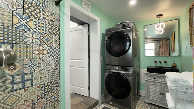 laundry area featuring stacked washer and clothes dryer