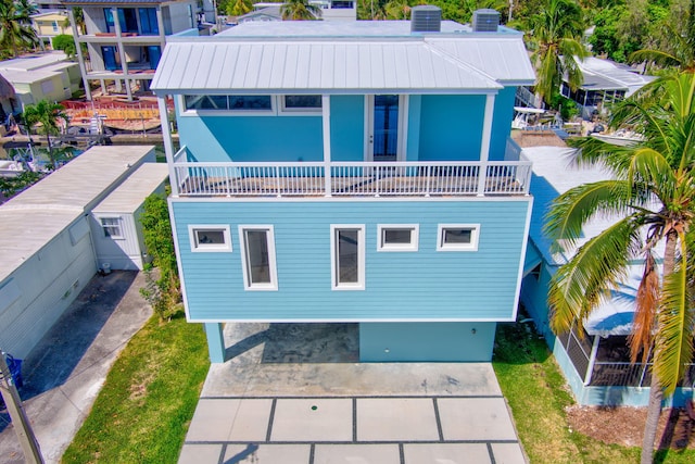 back of property featuring a balcony and central air condition unit