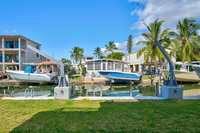 view of dock featuring a water view and a lawn