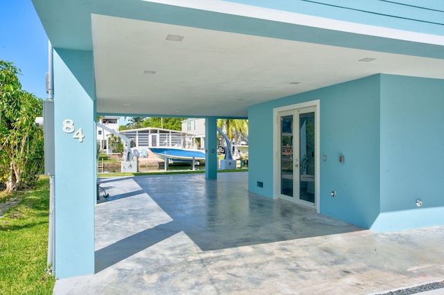 view of patio / terrace with french doors and a carport