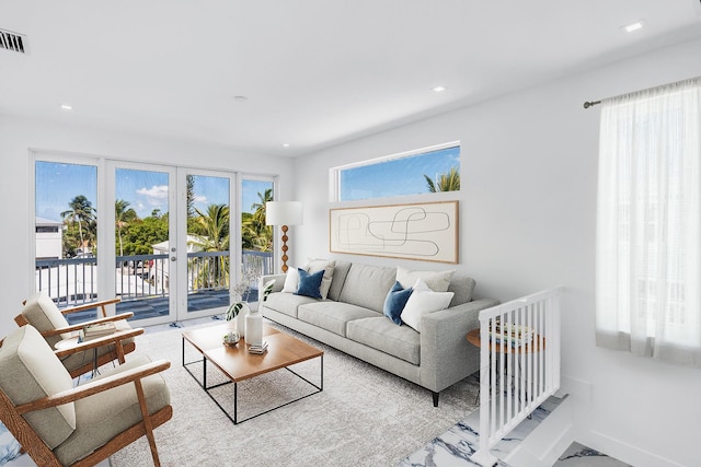 living room featuring plenty of natural light and french doors