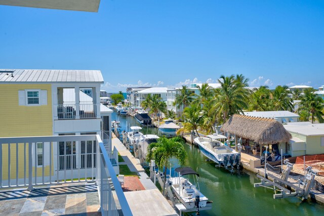 balcony featuring a dock and a water view