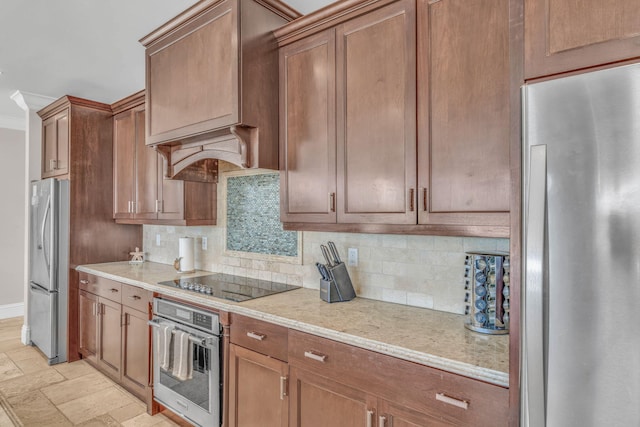 2394 Coco Plum Dr, Marathon, FL 33050 - kitchen with stainless steel appliances, tasteful backsplash, baseboards, light stone finish flooring, and brown cabinets