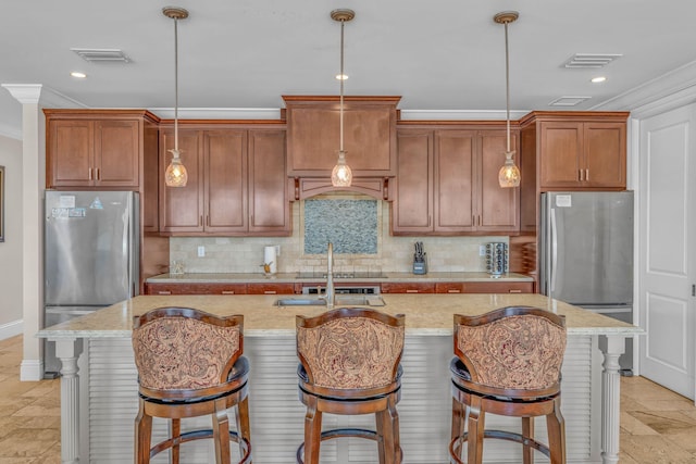 2394 Coco Plum Dr, Marathon, FL 33050 - kitchen with freestanding refrigerator, crown molding, tasteful backsplash, hanging light fixtures, and a center island with sink