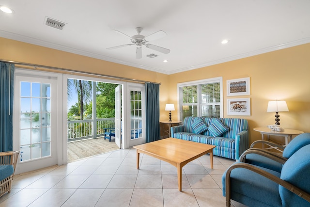 tiled living room featuring ornamental molding, ceiling fan, and french doors