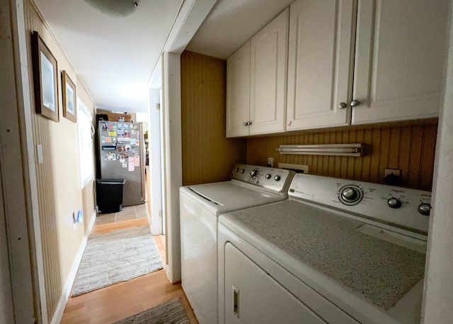 2 Riviera Dr, Big Coppitt, FL 33040 - washroom featuring baseboards, cabinet space, light wood-style floors, and washing machine and dryer