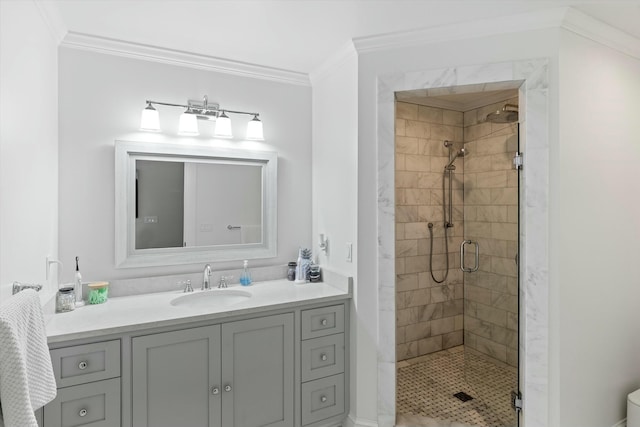 bathroom with ornamental molding, vanity, and walk in shower