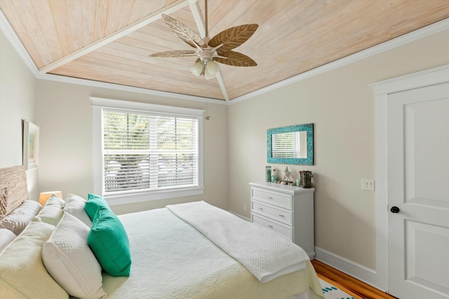 bedroom featuring hardwood / wood-style flooring, ornamental molding, ceiling fan, and wood ceiling