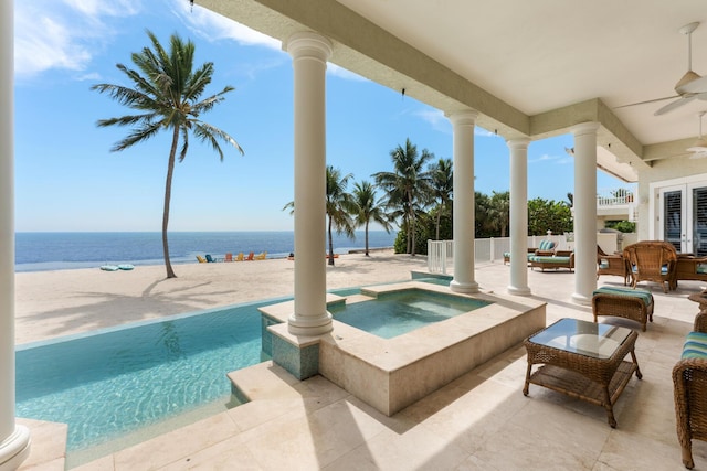 75931 Overseas Hwy, Islamorada, FL 33036 - view of pool featuring ceiling fan, a water view, an outdoor hangout area, a patio, and a pool with connected hot tub