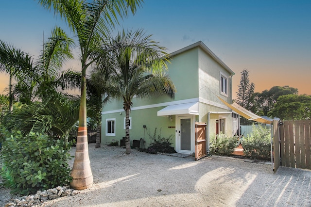 view of front of property featuring fence and stucco siding