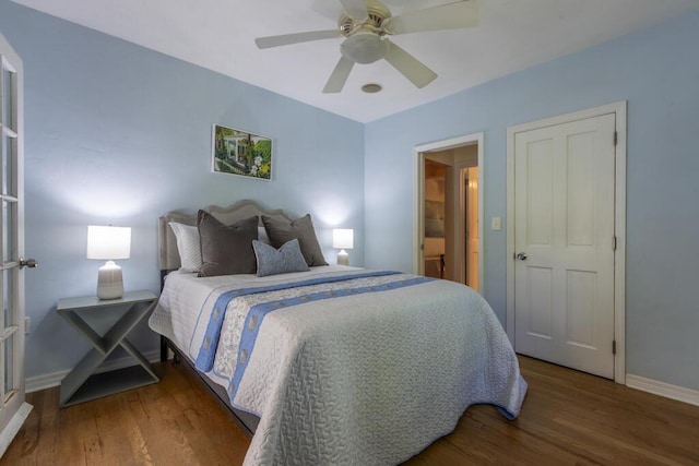 bedroom with dark hardwood / wood-style floors and ceiling fan