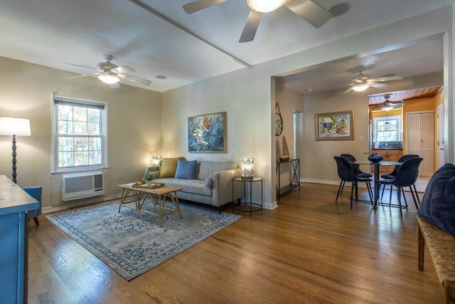 living room featuring hardwood / wood-style flooring and an AC wall unit