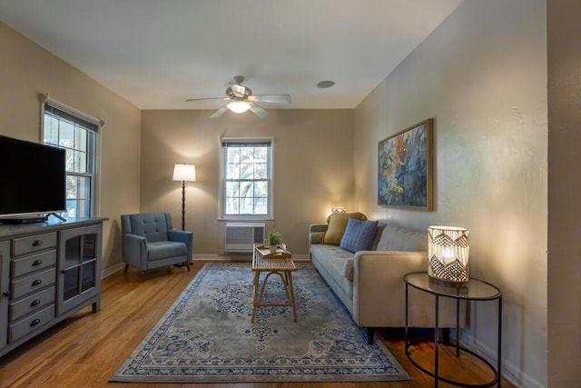 living room featuring plenty of natural light, light hardwood / wood-style floors, and ceiling fan