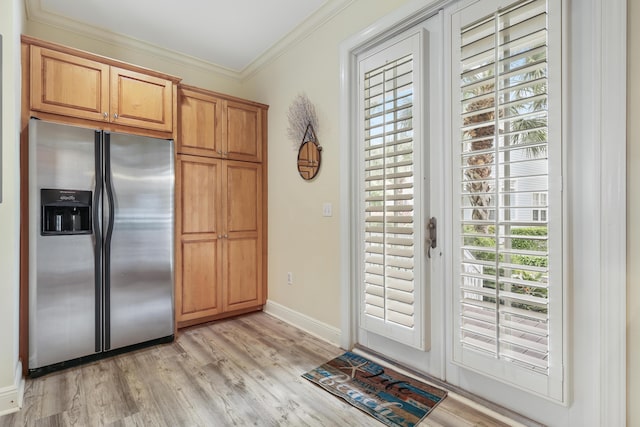 kitchen featuring crown molding, light hardwood / wood-style flooring, and stainless steel fridge with ice dispenser