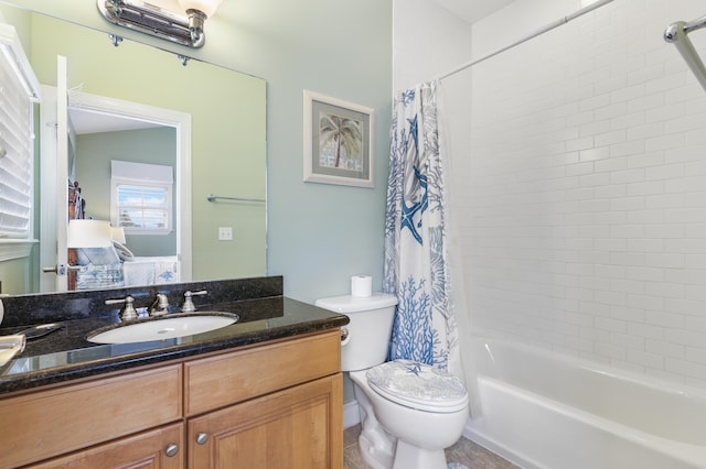 full bathroom featuring shower / bath combination with curtain, vanity, and toilet