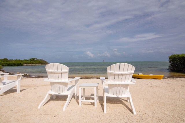 view of patio / terrace featuring a beach view and a water view