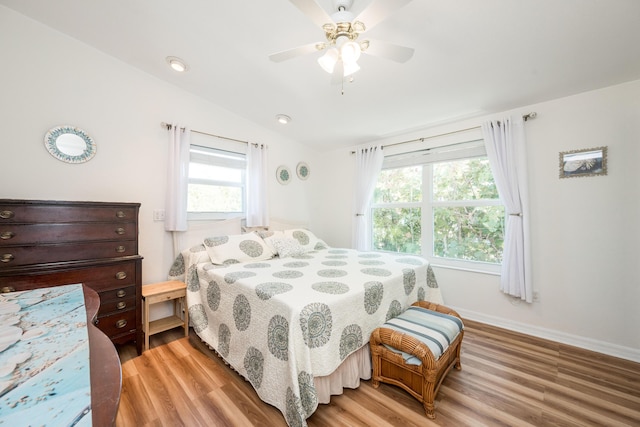 bedroom with lofted ceiling, wood-type flooring, and ceiling fan