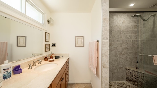 bathroom with vanity and a shower with shower door