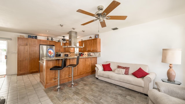 tiled living room with ceiling fan