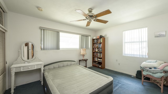 carpeted bedroom featuring multiple windows, a closet, and ceiling fan