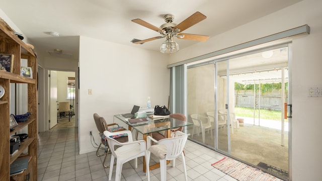 tiled dining room featuring ceiling fan