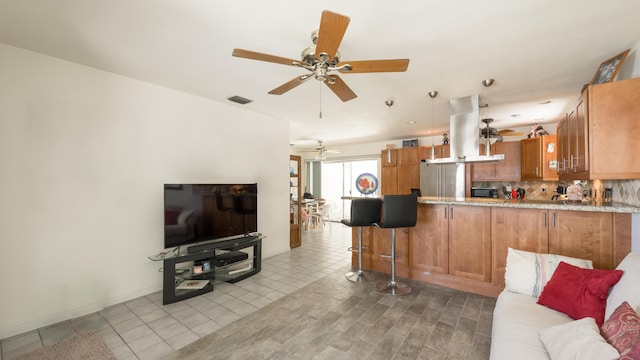 tiled living room with ceiling fan