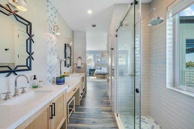 bathroom featuring hardwood / wood-style flooring, vanity, and walk in shower