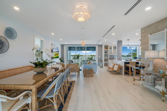 dining room with light hardwood / wood-style flooring and plenty of natural light