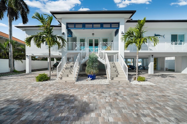 exterior space with a carport, covered porch, and french doors