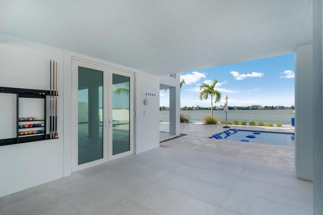 view of patio / terrace featuring a water view and french doors