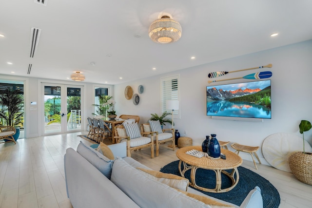 living room with french doors and light hardwood / wood-style floors