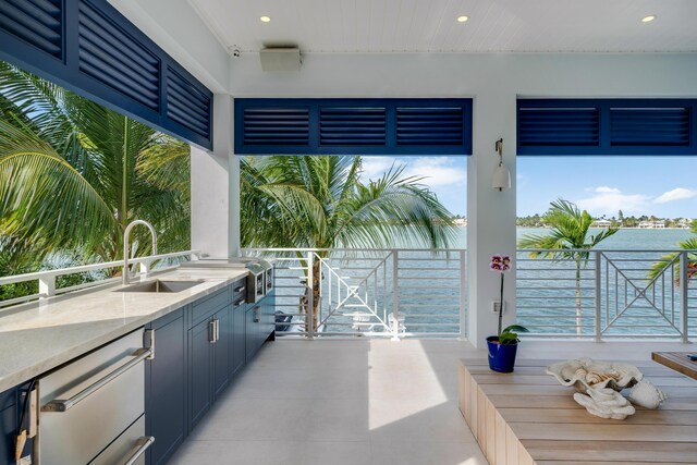 view of patio featuring an outdoor kitchen and sink