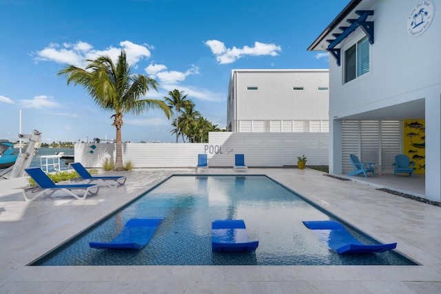 view of swimming pool featuring a patio area