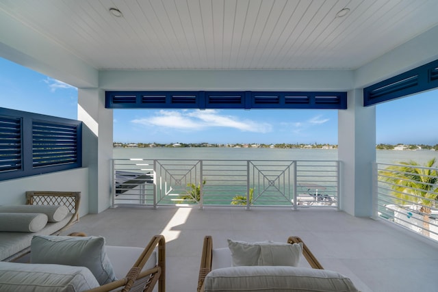 view of patio with a balcony and a water view