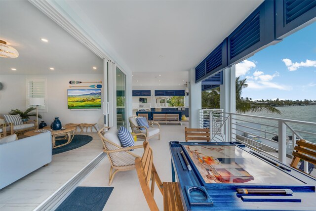 view of patio / terrace featuring a water view and a balcony