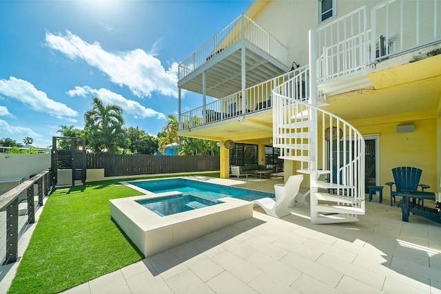 view of swimming pool with an in ground hot tub and a patio area