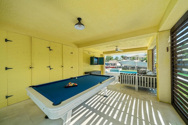 game room featuring pool table and a textured ceiling