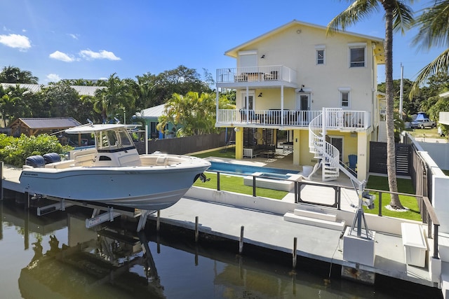 exterior space with a water view, a balcony, and a patio