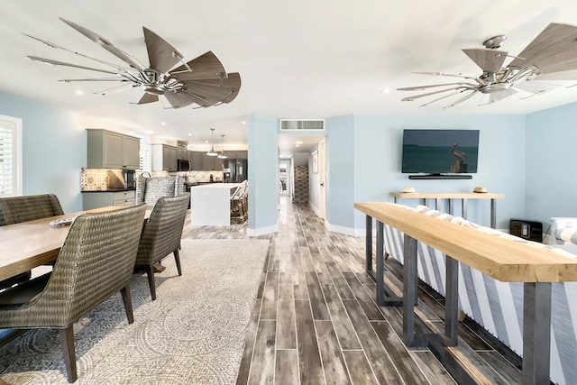 dining room with dark hardwood / wood-style floors and ceiling fan