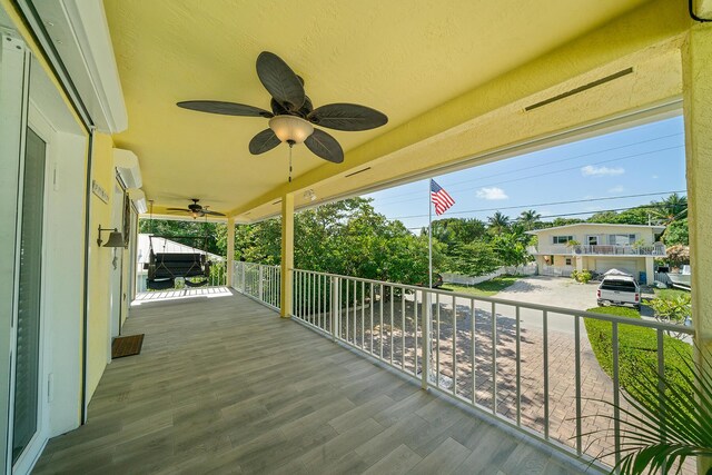 exterior space featuring ceiling fan, a porch, and a wall mounted AC