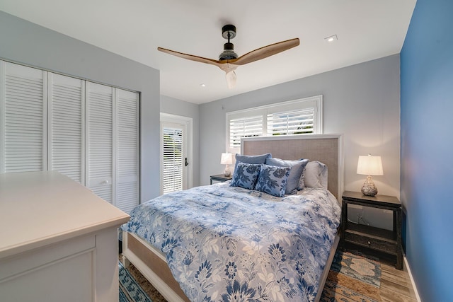 bedroom featuring hardwood / wood-style flooring, a closet, and ceiling fan