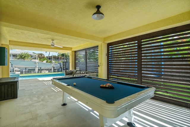 recreation room featuring pool table and a textured ceiling