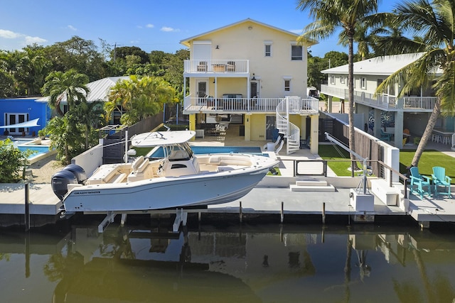 dock area featuring a water view and a patio